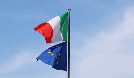 The Italian flag waves with the European Union flag.の写真素材