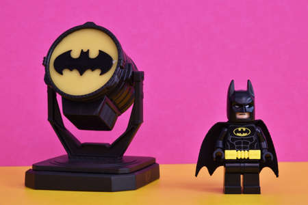 Bologna - Italy - May 23, 2022: Lego Batman miniature with Batsignal on display, isolated on pastel color backgroundのeditorial素材