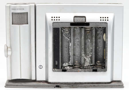 Oxide corrosion inside the battery compartment of an electronic device isolated on whiteの写真素材