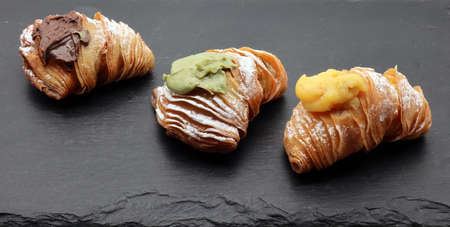 Fresh Italian dessert Sfogliatina on black display