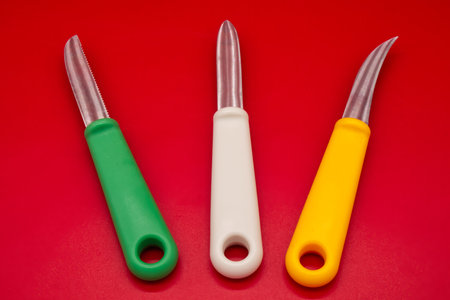 Knives of different shapes isolated on red backgroundの写真素材