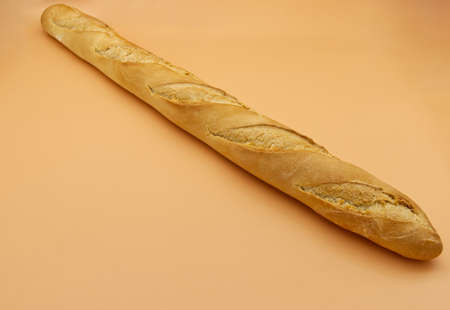 French Baguette Bread isolated on orange backgroundの写真素材