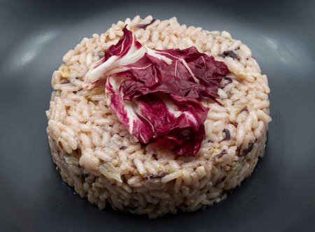 Risotto with red radicchio in a black dish. Italian cuisine. Close-upの写真素材