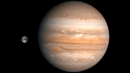 Image comparing the sizes of Jupiter and Earth.の写真素材