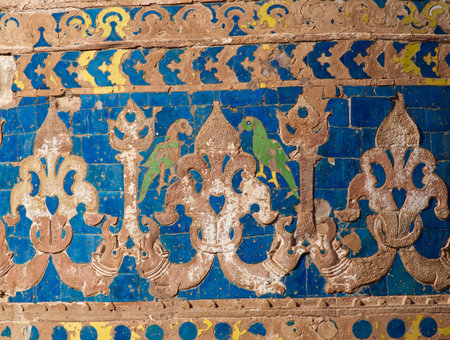 Ancient weathered wall at Gwalior fort with traditional patterns and parrots. Gwalior Qila, Madhya Pradesh, India.の写真素材