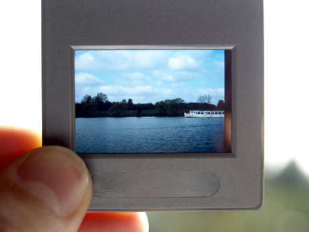 Hand holding colour slide filmの写真素材