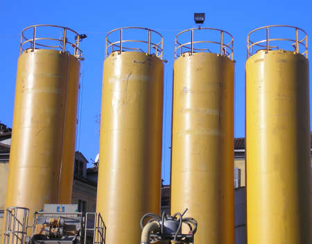 Yellow water tanks over a blue skyの写真素材