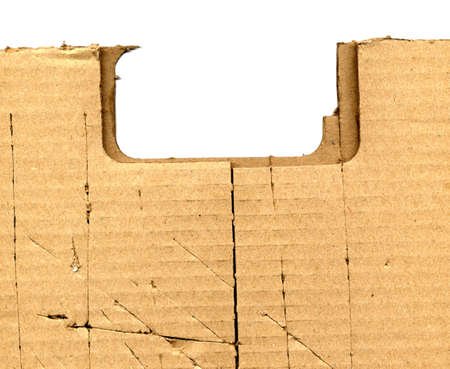 Brown torn corrugated cardboard sheet background with cuts