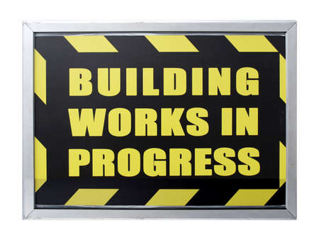 Building works in progress sign isolated over whiteの写真素材