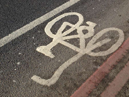 Bicycle lane sign painted on a streetの写真素材