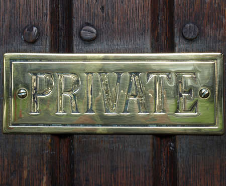Private label on golden plate over a wooden doorの写真素材