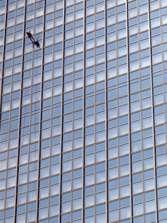 Window cleaner man climbing a skyscraper facadeの写真素材