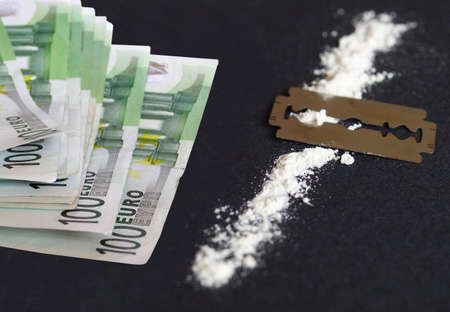 Cocaine, razor blade and money (simulation using wheat flour, no actual drugs used)の写真素材