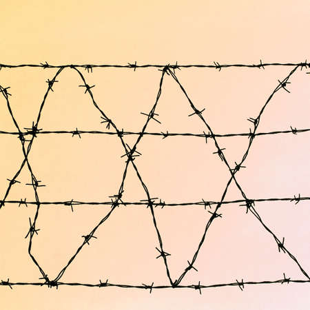 Barbed wire over red sky at sunset