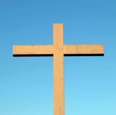 A wooden Christian cross over a blue skyの写真素材