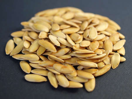 A heap of brown yellow melon seedsの写真素材