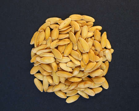 A heap of brown yellow melon seeds
