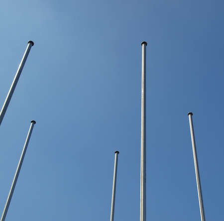 Flagpole flagstaff mast over a blue sky backgroundの写真素材