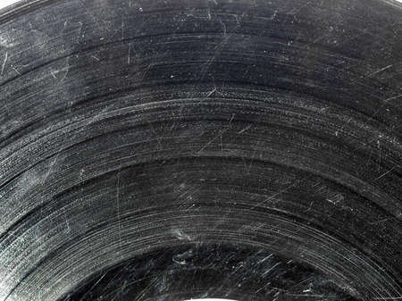 Badly damaged scratched vinyl record vintage analog music recording mediumの写真素材