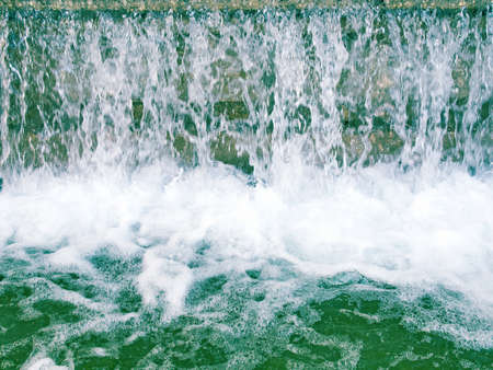 Detail of a water fall or cascade with foamの写真素材