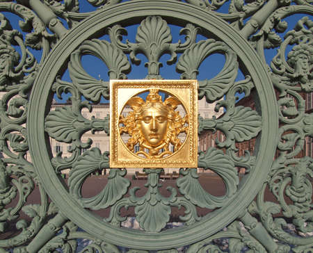 Ancient baroque golden mask on Palazzo Reale (The Royal Palace) fence in Turin Italy