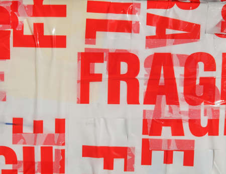 Fragile warning label on tape on a packet parcel for mail post shippingの写真素材