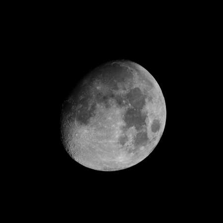 Moon almost full seen from the northern hemisphere with a telescope in black and whiteの写真素材