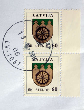 RIGA, LATVIA - FEBRUARY 21, 2014: A stamp printed by Latvian Posts shows the coat of arms of Stendeの写真素材