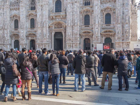 MILAN, ITALY - FEBRUARY 23, 2014: People attending mass in front of Milan cathedral celebrated by Filipino Cardinal Luis Antonio Tagle Archbishop of Manila and Antonio Scola Archibishop of Milanのeditorial素材