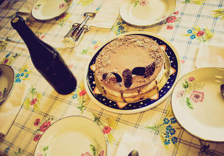 Vintage looking Table with cake and wineの写真素材