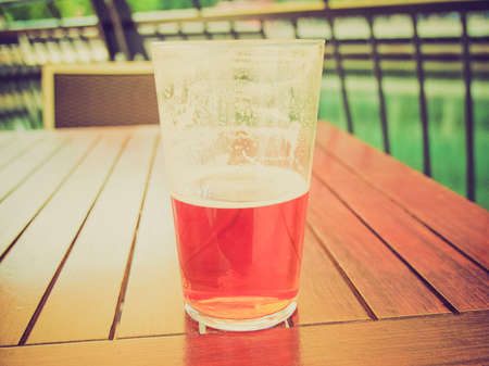 Vintage looking Large glass pint of beer alcoholic drinkの写真素材