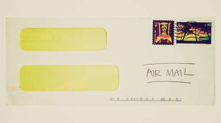 Vintage looking Letter or small packet envelope isolated over whiteの写真素材
