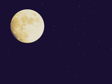 Vintage looking Full moon over dark sky with starsの写真素材