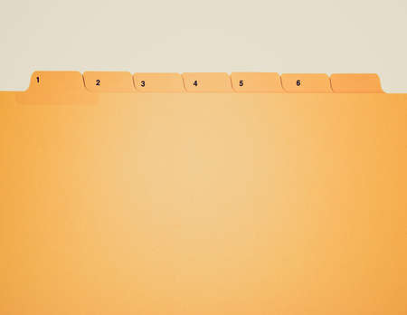 Vintage looking Office folder with numbered tabs isolated on whiteの写真素材