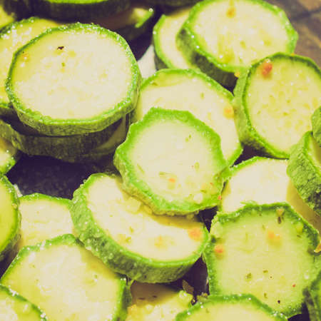 Vintage looking Green courgettes or zucchini vegetables useful as a backgroundの写真素材