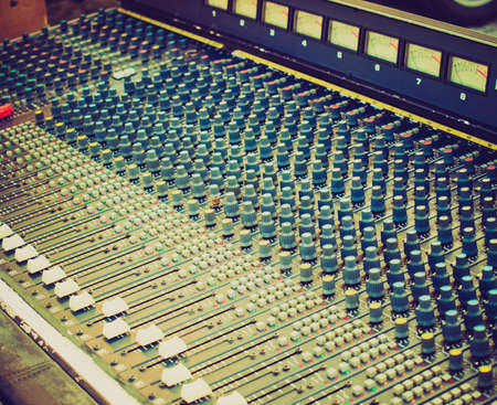 Vintage looking Detail of a soundboard mixer electronic device