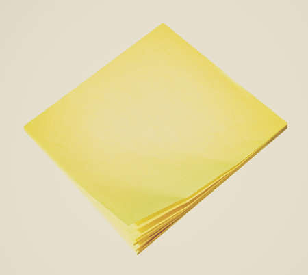 Vintage looking Yellow postit notepad isolated over white background