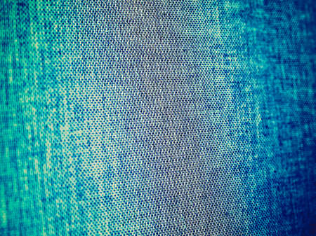 Vintage looking Blue Jeans fabric useful as a backgroundの写真素材