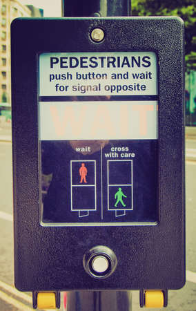 Vintage looking A pedestrian crossing sign - press button and wait for signal opposite
