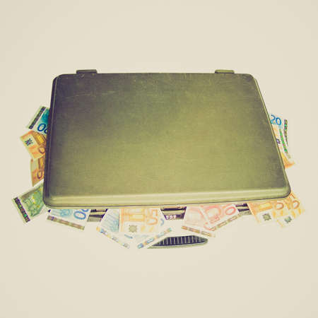 vintage looking money in a suitcase isolated over white