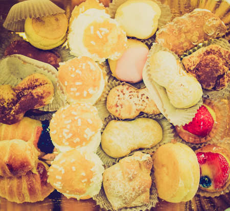 Vintage looking Mixed pastries with chocolate, cream, fruitの写真素材