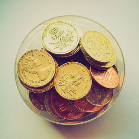 Vintage looking British Pounds coins (UK currency) in a boxの写真素材