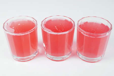 Pink grapefruit juice glasses on continental breakfast tableの写真素材
