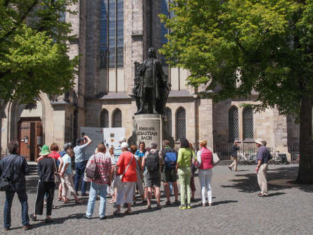 LEIPZIG, GERMANY - JUNE 12, 2014: People visiting the Neues Bach Denkmal new Bach monument front of the St Thomas Kirche church where Johann Sebastian Bach is buriedのeditorial素材