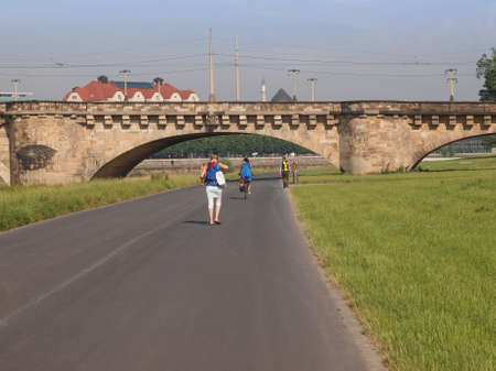 DRESDEN, GERMANY - JUNE 11, 2014: People walking on bankside park on river Elbeのeditorial素材