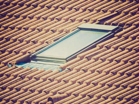 Vintage looking Detail of red roof tiles and roof windowの写真素材