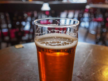A pint of English ale beer in a pubの写真素材