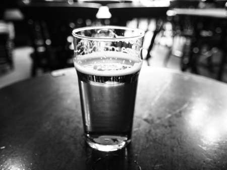 Vintage looking pint of English bitter ale in a pubの写真素材