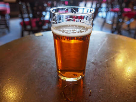 A pint of English ale beer in a pubの写真素材