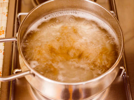 Pasta in boiling water in a panの写真素材